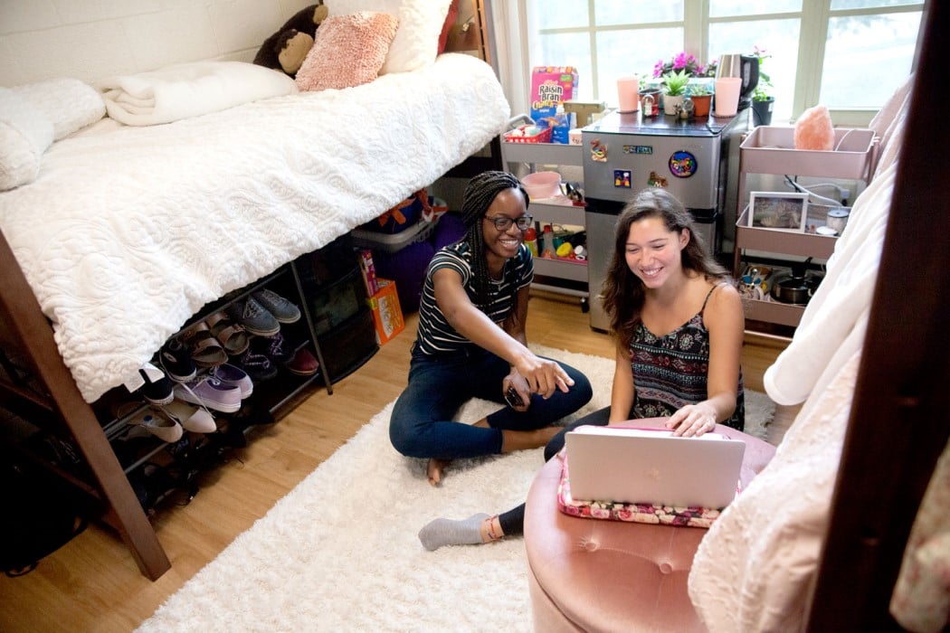 Two UF residence hall students enjoying the comforts of their dorm room