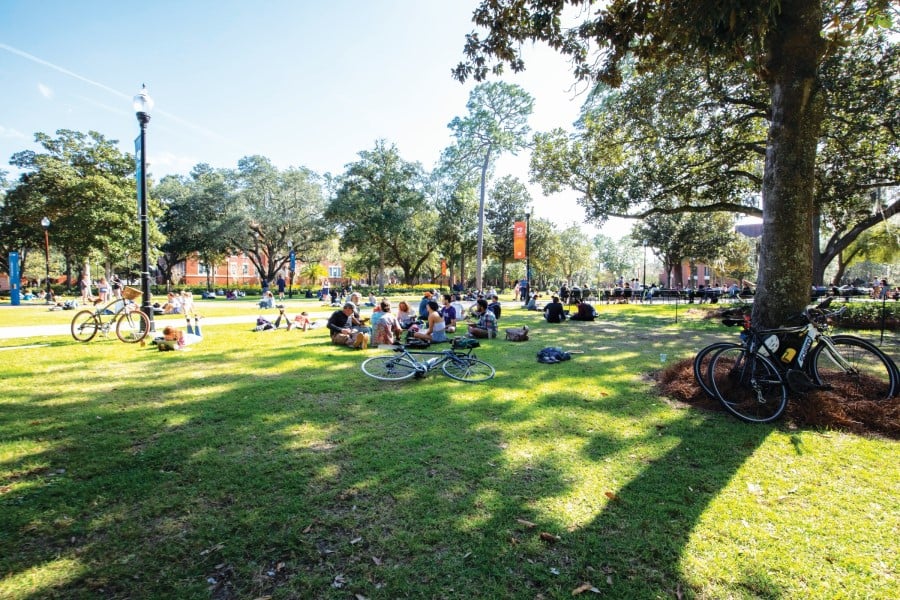 students gather with bikes scattered about in plaza