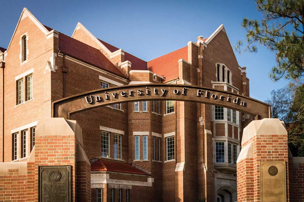 outside view of heavener hall, brick building with arch saying University of Florida