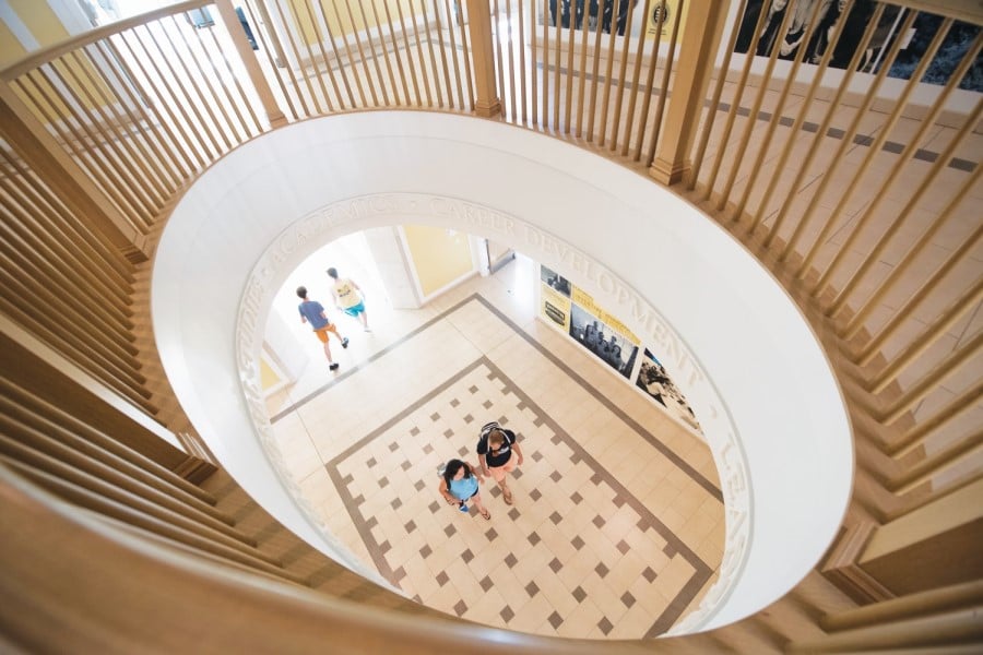 view of students on first from the second floor's large, open rotunda