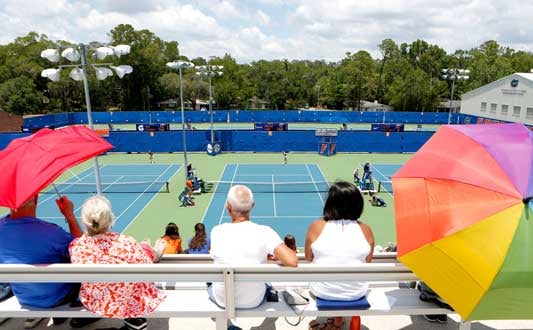 Fans watching tennis at the Alfred Ring Tennis facility on the UF campus